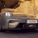 Gray Porsche Sports Car Driving Through a Tunnel Front View with Illuminated Headlights and a Clutch License Plate
