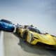 Two High performance Race Cars Race Side by Side on a Racetrack the Yellow Car in Front and the Blue Car Closely Behind with Motion Blur and Red and white Curbs in the Foreground
